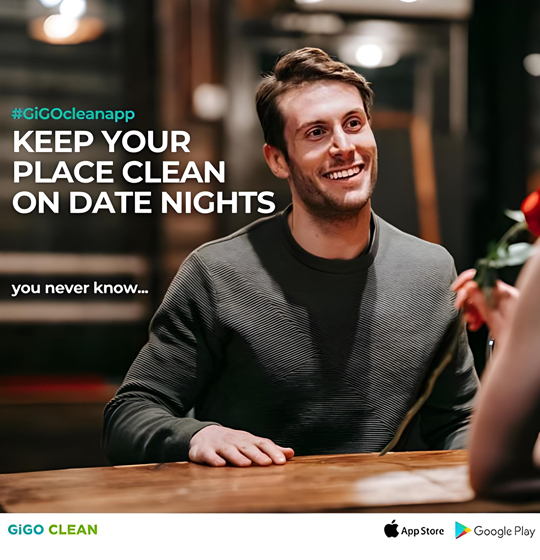 Smiling man sitting at a dinner table on a date night, holding hands with someone across the table, with text promoting keeping your place clean.