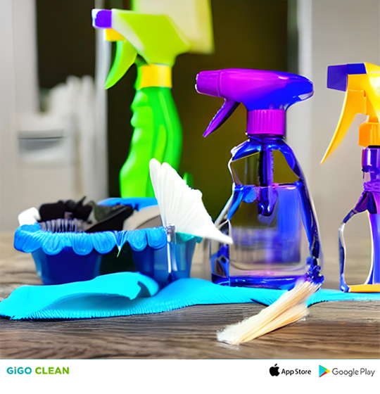 Assorted colorful spray bottles, cleaning cloths, and brushes arranged on a table, ready for house cleaning.